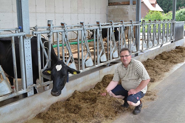 JOSERA farmer Schröder sitting next to cows